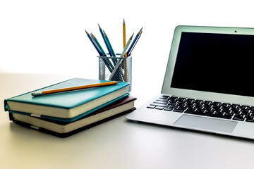 Still-life portrait of computer, pen, coffee mug on table, busin