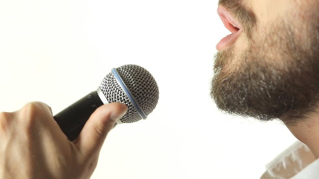 Close-up of a blue-eyed man with a beard wearing a jacket
