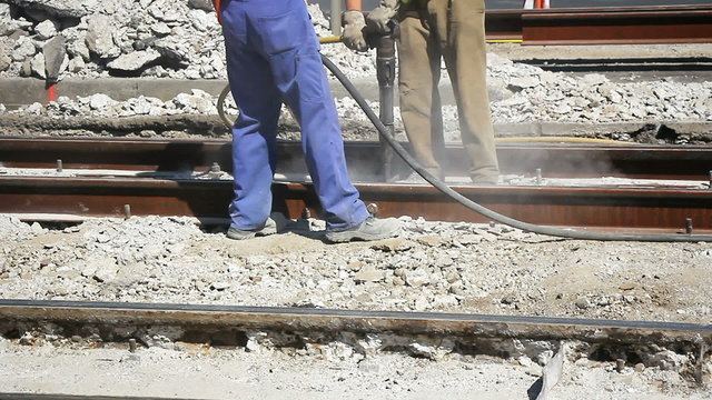 Two Workers with pneumatic hammer 