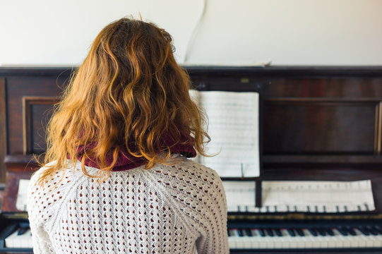 Young Woman Playing The Piano