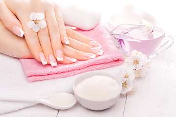 Fototapeta na wymiar french manicure with essential oils, apricot flowers. spa