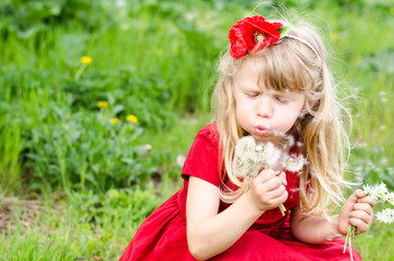 blond girl blowing dandelion