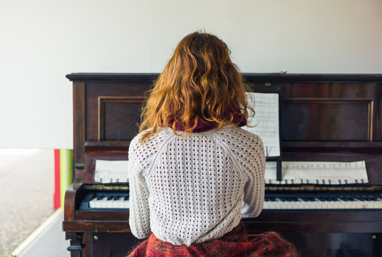 Young woman playing the piano
