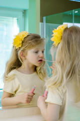 Fototapeta premium blond girl painting her lips