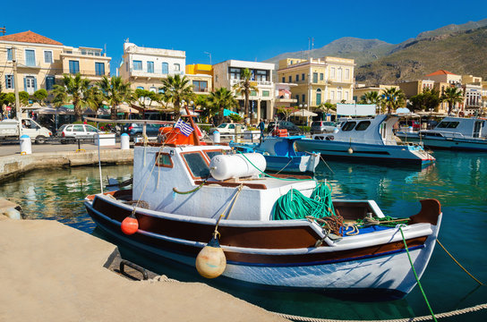 Colorful wooden boat in cosy Greek port in summer time