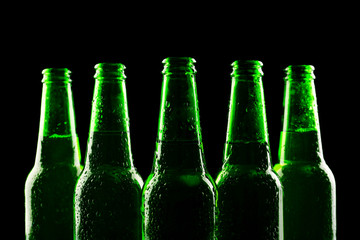 glass bottles of beer on dark background