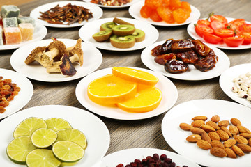 Different products on saucers on wooden table, closeup
