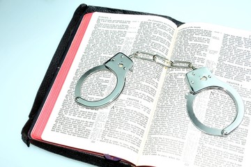 Justice concept with handcuffs and bible