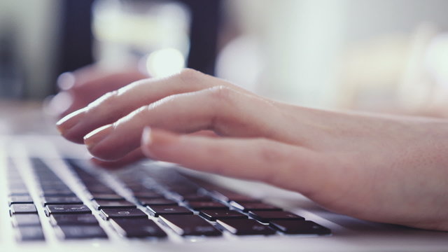 Closeup Of Business Woman Hand Typing On Laptop Keyboard