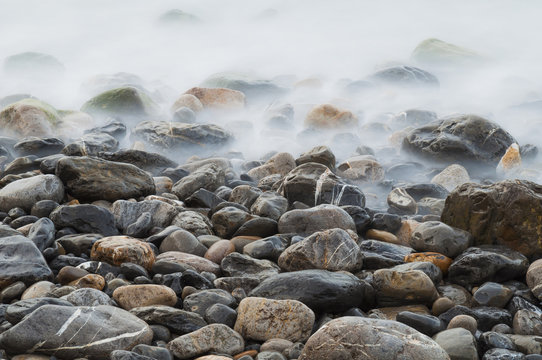 Pebbles And Water On The Sea Shore