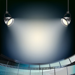 Fototapeta premium blue background with spot lights and filmstrip