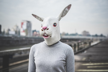 surreal woman with a rabbit mask - conceptual shot