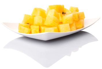 Bite sized yellow watermelon in a white plate