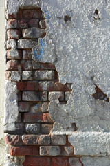 Crumbling wall of brick and plaster
