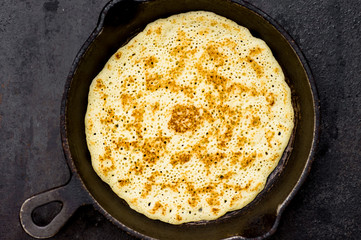 Russian pancake blin in a frying pan