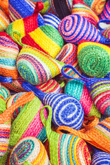 Close up stack of colorful handmade coin bag in market