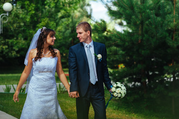 Bride and Groom at wedding Day walking Outdoors on spring nature