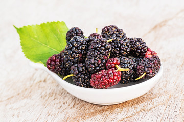 Mulberries with leaf isolated on white background