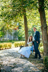 Fototapeta premium Bride and Groom at wedding Day walking Outdoors on spring nature