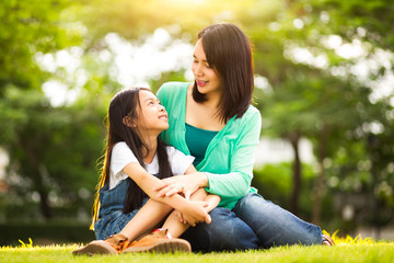 Fototapeta premium Happy young mother with her daughter at park