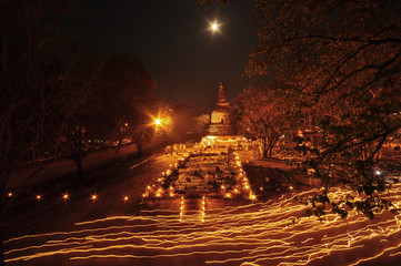 Buddhism Candle Ceremony, walk with lighted candles in hand around a temple, Thailand