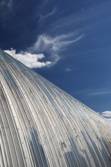 Naklejka premium metal hangar roof against the blue sky