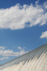 Fototapeta na wymiar metal hangar roof against a blue sky