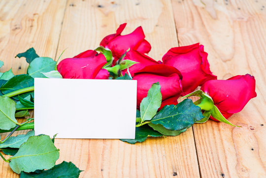 Red roses and empty tag for your text.