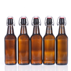 Fünf volle Bierflaschen in Reihe isoliert