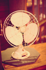 Vintage filter: Vintage fan on wood table in old shop