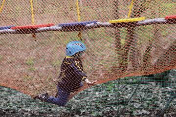 Boy climbing into a net