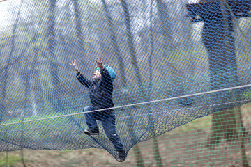 Child climbing into a net