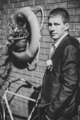 Happy Handsome caucasian groom in tuxedo thinking and putting on