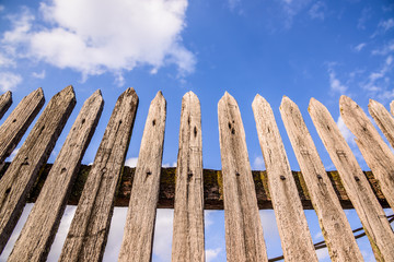 Old wooden fence on a blue sky