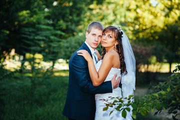 Fototapeta premium Bride and Groom at wedding Day walking Outdoors on spring nature