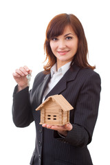 adult realtor with keys and wooden toy house,it could be the