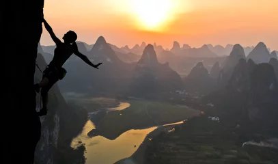  Silhouette of female athlete on Chinese mountain sunset © alexbrylovhk