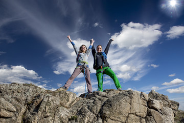Group of two happy female climbers  celebrates victory