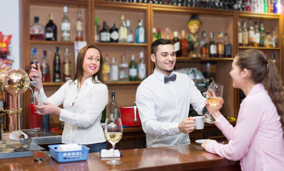 Girl flirting with barman at counter