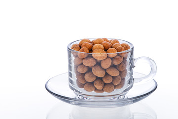 Cup of coffee-flavored peanut on white isolated background with