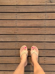 feet on wooden floor. 
