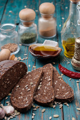 Traditional dark bread with sunflower seeds on a wooden table.