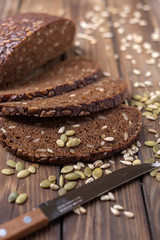 Fototapeta na wymiar Traditional dark bread with sunflower seeds on a wooden table.