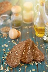 Traditional dark bread with sunflower seeds on a wooden table.