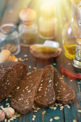 Traditional dark bread with sunflower seeds on a wooden table.