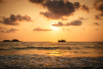 Naklejka na ściany i meble Fishermen boat at sunset in the Thailand