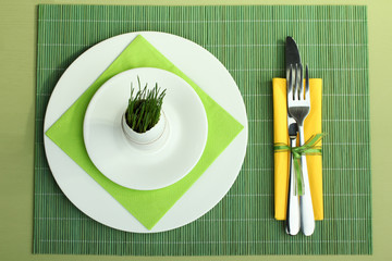 Green wheat sprouts in egg on a wooden background. Tableware