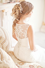 Fototapeta na wymiar Young attractive bride in ivory tenderness wedding dress