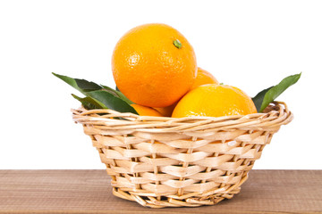 basket of oranges on wooden board