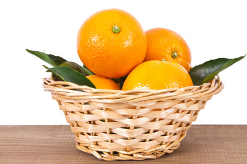 basket of oranges on wooden board